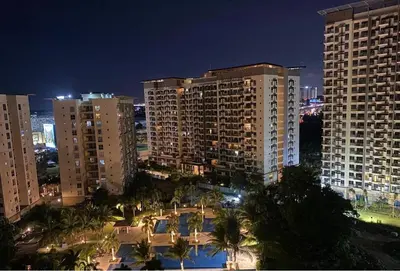 a view of a city at night with tall buildings at Staycation in Brgy Buli in Manila