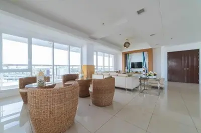 a living room with a couch and a table and chairs at Staycation in Brgy Buli in Manila