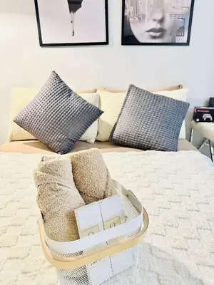 a basket on a bed with pillows on it at Condotels RQ Hob in Manila