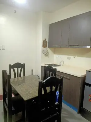 a kitchen with a table and chairs and a counter at Condotels RQ Hob in Manila