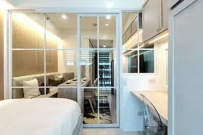 a room with a bed and a kitchen with glass walls at Hotel Comfort FREE Parking Fame Mall Access in Manila