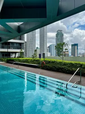 a swimming pool with a city skyline in the background at Hotel Comfort FREE Parking Fame Mall Access in Manila