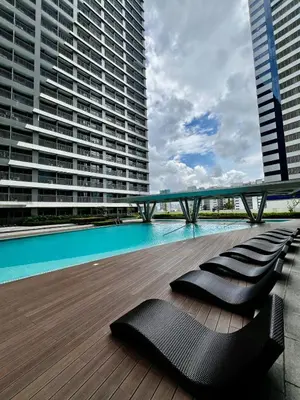 a deck with a pool and benches on a building at Hotel Comfort FREE Parking Fame Mall Access in Manila