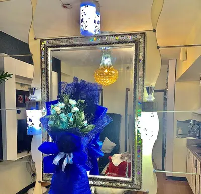 a mirror in a room with a blue item at 1 Br - Royalty Vacation - Edsa Makati in Manila