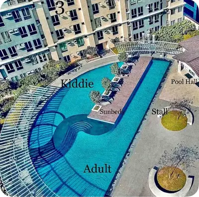 arial view of a swimming pool in front of a building at 1 Br - Royalty Vacation - Edsa Makati in Manila