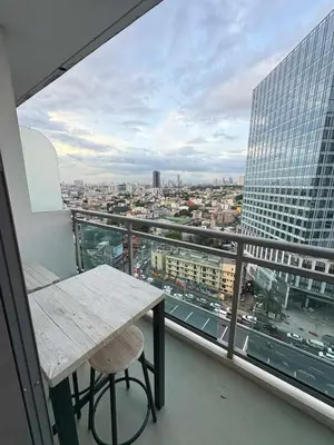 a balcony with a table and a view of a city at Staycation at Brgy Sucat in Manila