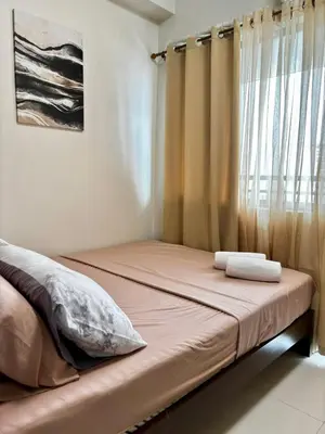 a bed in a room with a window at Fame Residence Tower 4 near Greenfield and Shaw MRT in Sampong