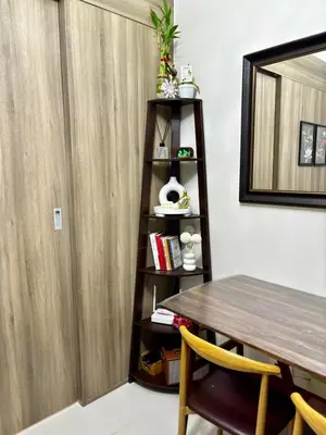 a dining room with a table and a shelf at Fame Residence Tower 4 near Greenfield and Shaw MRT in Sampong