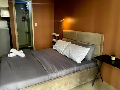 a bedroom with a bed with a white pillow at XYz's Condo - Walk To MNL T3 via Runway Manila in Manila