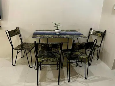 a table and chairs with a potted plant on it at XYz's Condo - Walk To MNL T3 via Runway Manila in Manila