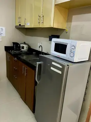 a microwave sitting on top of a refrigerator in a kitchen at XYz's Condo - Walk To MNL T3 via Runway Manila in Manila