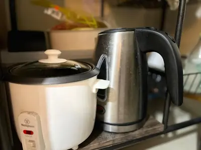 a black and white coffee pot sitting on a shelf at Staycation and WFH with Netflix and Pool for up to 4 guests in Manila