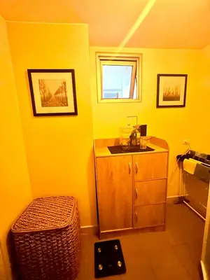 a bathroom with a sink and a yellow wall at Staycation and WFH with Netflix and Pool for up to 4 guests in Manila