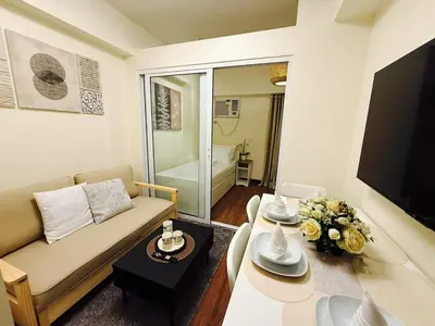 a living room with a couch and a table at The Camden Place Aesthetic Elegant Condo Unit 15 in Manila