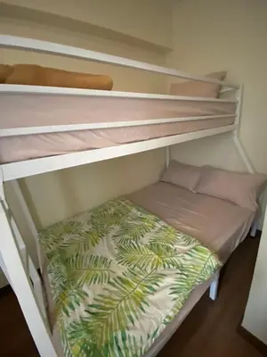 a bunk bed in a room with a bed underneath it at La Mari Staycation 2bedroom at Prisma Residences in Manila