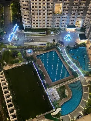 an overhead view of a pool in a city with tall buildings at La Mari Staycation 2bedroom at Prisma Residences in Manila