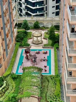 an overhead view of a courtyard between two buildings at Cozy Apartment in Venice Luxury Residences BGC in Manila
