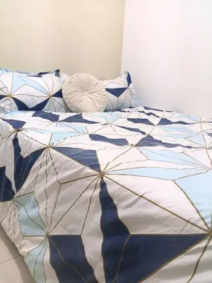 a blue and white comforter on a bed at Terra Nueve Escape - 1br with Balcony Staycation in Manila