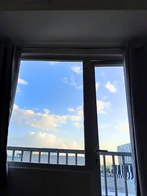 a window in a room with a view of the ocean at Terra Nueve Escape - 1br with Balcony Staycation in Manila