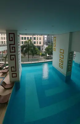 a large swimming pool in a building with a hotel sign at New 2BR Suite Milano Residences Poblacion Makati 110sqm in Sampong