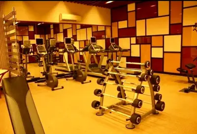 a gym with several rows of exercise bikes in a room at Jazzy Flat in Manila