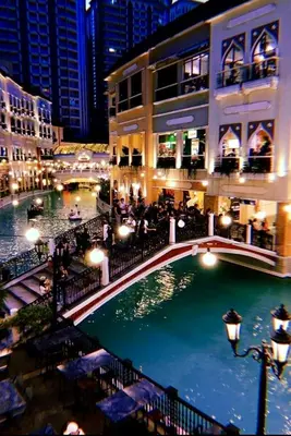 a bridge over a river in a city at night at Jazzy Flat in Manila