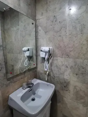 a bathroom with a sink and a mirror at Ancalm condon in Manila