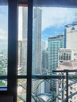 a view of a city skyline from a window at Ancalm condon in Manila