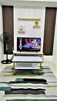 a living room with a tv and a coffee table at City View with Balcony at Kasara Residences C5 Pasig in Manila