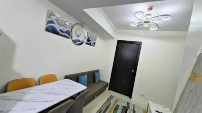a room with a table and chairs and a black door at City View with Balcony at Kasara Residences C5 Pasig in Manila