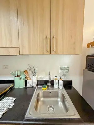 a kitchen counter with a sink in a kitchen at Staycation near Mall of Asia in Manila