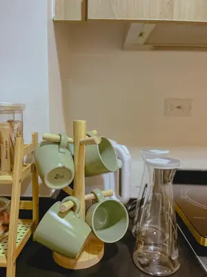 a kitchen counter with green mugs and a blender at Staycation near Mall of Asia in Manila