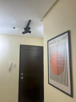 a poster of a tennis ball on the wall next to a door at JFS Staycation at Birch Tower - Cozy Home in Manila