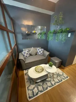 a living room with a couch and a table at Staycation by Purple Tree in Manila