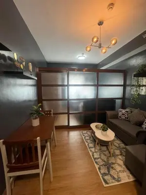 a living room with a couch and a table at Staycation by Purple Tree in Manila