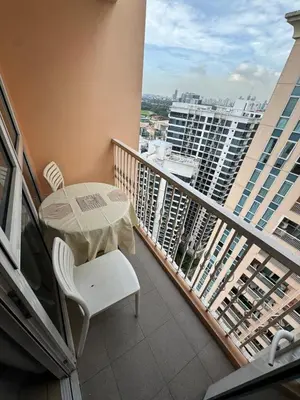 a balcony with a table and chair on a building at Casa Venice Rustic Pet Friendly Studio Balcony in Manila