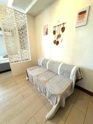 a room with a bench in the corner of a room at Casa Venice Rustic Pet Friendly Studio Balcony in Manila