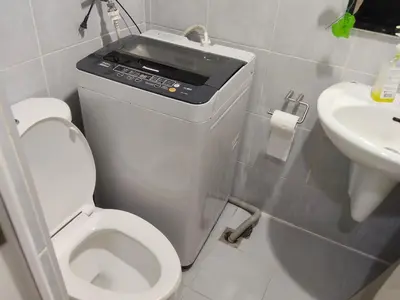 a small bathroom with a toilet and a sink at Sea Residences Anna Staycation in Manila