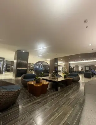 a lobby with couches and tables in a building at Tan LexJie Havens and Hideout in Manila