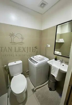 a bathroom with a toilet and a sink at Tan LexJie Havens and Hideout in Manila