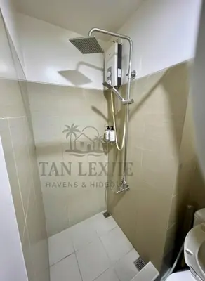 a shower in a bathroom with a toilet at Tan LexJie Havens and Hideout in Manila