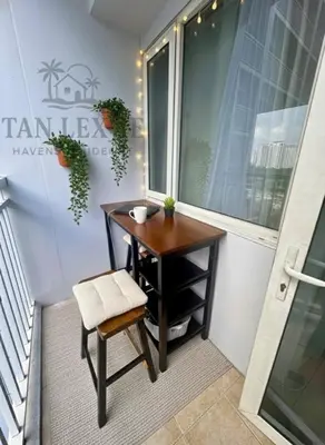 a small table and a chair in front of a window at Tan LexJie Havens and Hideout in Manila