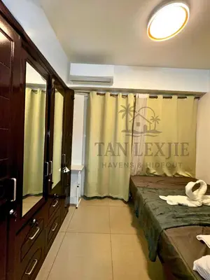 a room with a bed with a sign on the curtain at Tan LexJie Havens and Hideout in Manila