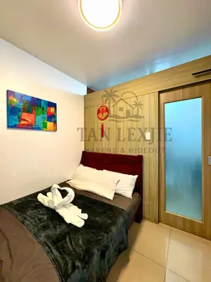 a bedroom with a bed with a white towel on it at Tan LexJie Havens and Hideout in Manila