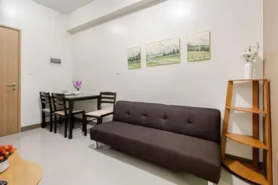 a living room with a couch and a table at Near SM BF & Shopwise SLEX Accessible 2BR for 4 in Manila