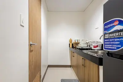 a kitchen with a sink and a counter top at Near SM BF & Shopwise SLEX Accessible 2BR for 4 in Manila