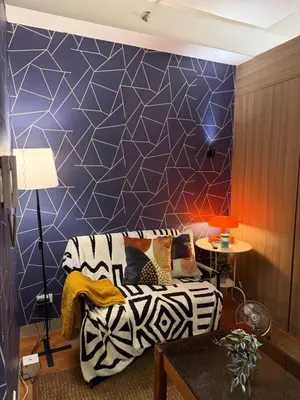 a living room with a couch and a blue wall at S&B rentals in Manila