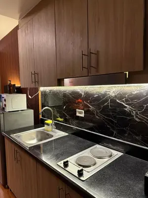 a kitchen with a sink and a counter top at S&B rentals in Manila