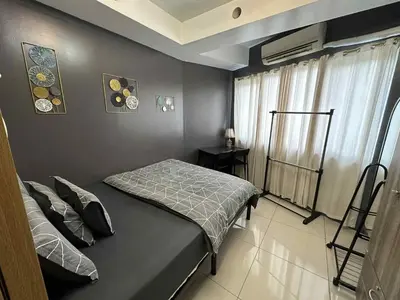 a small bedroom with a bed and a window at Shell residence Family room by Kathy in Manila