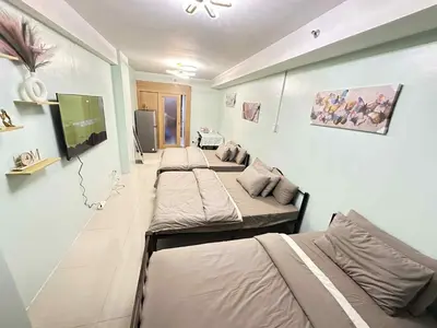 a row of beds in a room at Shell residence Family room by Kathy in Manila